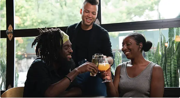 A group of people drink juice and laughing